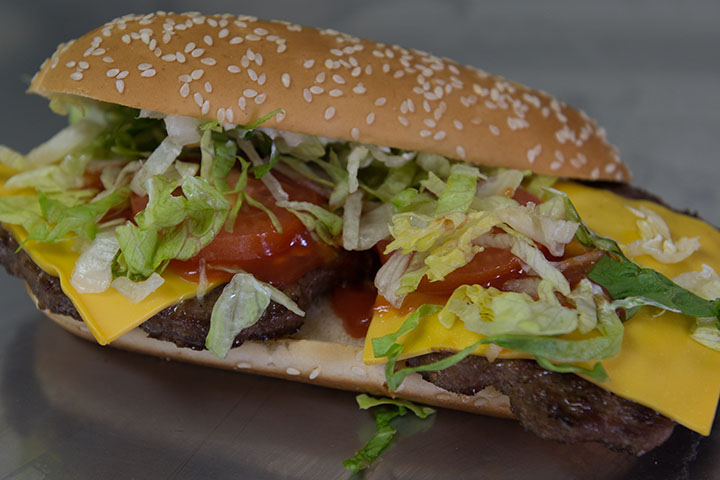 Meat PO-BOY with cheese, lettuce and tomato.